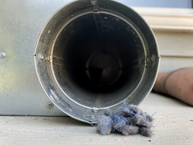Torrance Dryer Vent Cleaning technician using specialized equipment to clear severe dryer vent blockage in Torrance